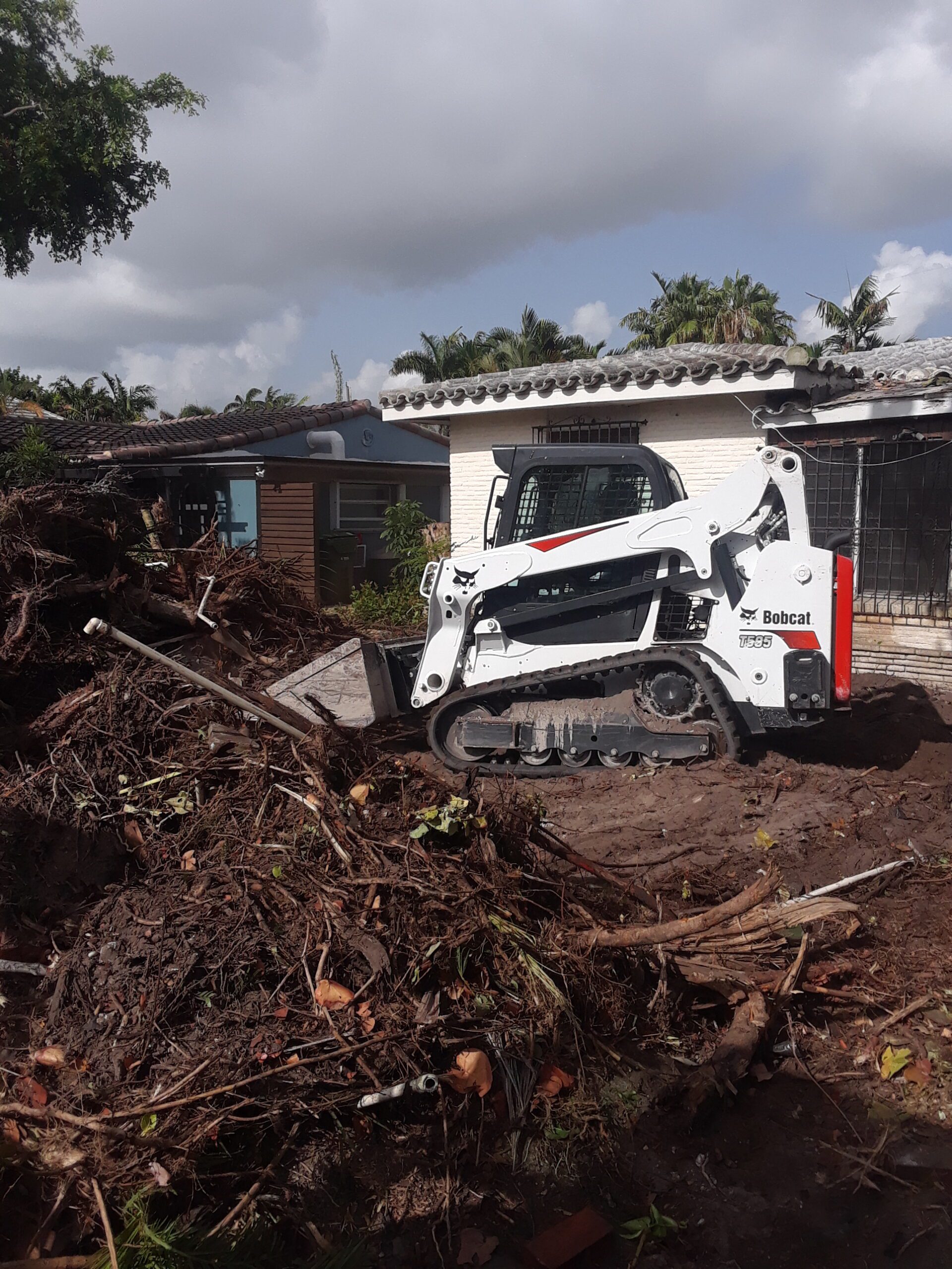 A White Bulldozer Removing A Pile Of Dirt